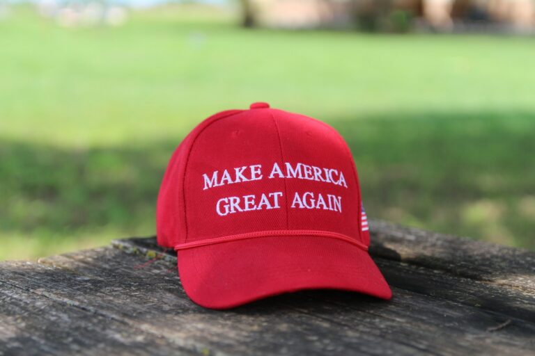 a red hat that says make america great again, donald trump